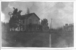 Two story house of Morris and Arline Whitham in Windsor with a windmill in the rear