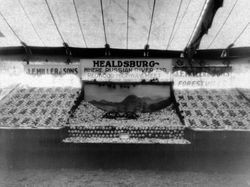 Gravenstein Apple Show displays by J. F. Miller & Sons, Healdsburg and Forestville, and in center "Healdsburg--Where Russian River and Redwood Highway Meet"