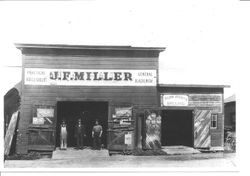 Three men in the entrance to J. F. Miller blacksmith shop in Sebastopol, 1880s or 1890s