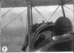 August Sam Huck at the controls of his "Jenny" biplane, about 1920