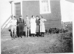 Karl Asman and five unidentified men and women stand in front of the Asman house at Bodega Bay, about 1919