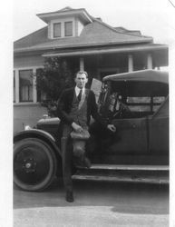 Volney T. Ballou standing in front of a car, about 1927