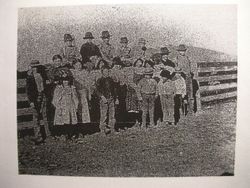 Students of Watson School, Bodega, California standing in front of a fence with their teacher, about 1900