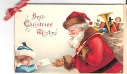 Best Christmas wishes—Christmas greeting with young girl handing Santa a letter