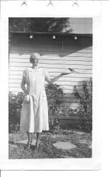 Lillian Brill Rosebrook feeding a tame mockingbird from her hand, 1930s