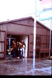 Unidentified people at entrance of shop or store