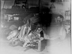 Wrecked car is seen in a repair garage, about 1933 or 1934