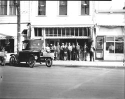 Group of men and one woman standing in front of an unidentified store, 1920s in Sebastopol