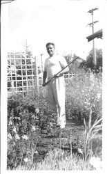 George F. Streckfus in his garden with a hoe, July 8, 1940