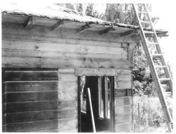 Burbank Cottage before renovations--ladder at eves at front door