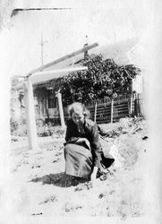 Blanche Riddell checking on a newly planted garden, about 1920