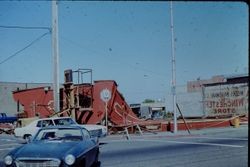 Building being torn down at corner of Burnett Street and South Main Street Sebastopol 1979. "Week's Hardware Co." and "The Winchester Store" signs painted on side of adjacent building