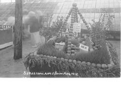 1912 Gravenstein Apple Show display of a camp with a campfire and animals that surround the camp