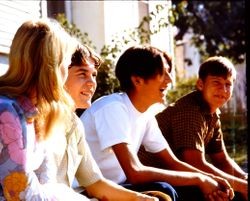 Unidentified teenagers sitting on a bench or wall, Sebastopol, California