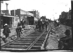 Railroad workers laying rails of P&SR electric railway down Main Street Sebastopol, about 1904