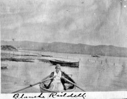 Blanche Riddell rowing a boat at Bodega Bay, about 1920