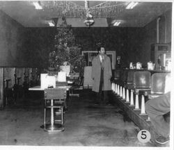 Ernie Julius in a heavy coat at his Pine Cone Restaurant at 162 North Main Street in Sebastopol, 1950s