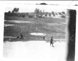 Boys at recess on the boy's side of the playground at Sebastopol Primary school playing tether ball, 1920s