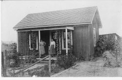 Two unidentified women on the porch of a small west Sonoma County home, about early 1900s