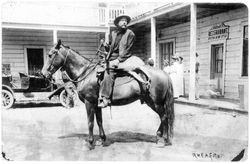 Frank Drago on a horse with a dead deer slung on the back of the horse, probably in Occidental, about 1915