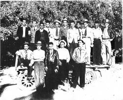 Group of Filipino workers stand on a flatbed in the apple orchards in Sebastopol