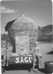 Scott & Carrie Roberts sit on SAGU float for the Gravenstein Apple Fair, about 1972