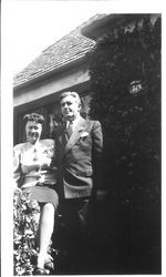 Bunni and George Streckfus in front of a house with house number 325, about 1940s