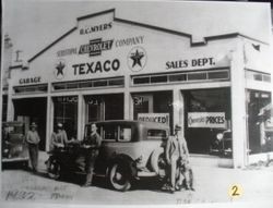 Pete Pellini standing under garage sign at R. C. Meyers Sebastopol Chevrolet Company/Texaco on Santa Rosa Avenue, about 1932