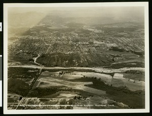 Aerial view of the Riverside Airport, showing a mountain ridge at center in front of a residential area, March 1932