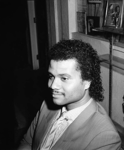 Unidentified man sitting at the Eagle Lite Salon, Los Angeles, 1984