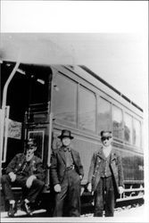 Three men at a streetcar