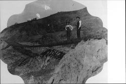 Two men standing on a track near sawmill