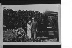 Bert Feige and Irene Gonnella in front of a truck filled with tan bark