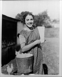 Girl carrying a pail of eggs at the Lytton Home