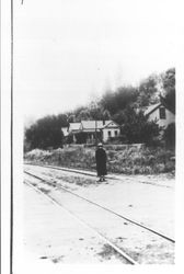 Margaret Adams walking along railroad tracks