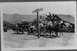 Wagons and an automobile picking up passengers for McCray's Resort