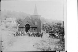 St. Phillips Catholic Church with a group of people in front of the Church