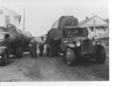 Two logging trucks in front of Richardson's Store