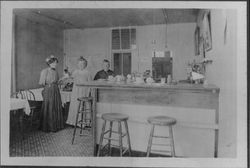 Three women inside a restaurant with a coffee bar