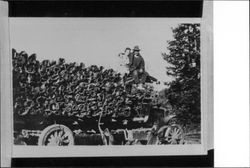 Ernest Speckter and Irene Gonnella sitting on top of a truck hauling tan bark