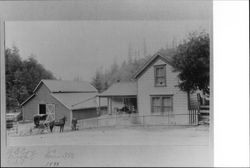 Coy family in front of their home and barn