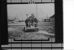 Four men on a railroad handcar