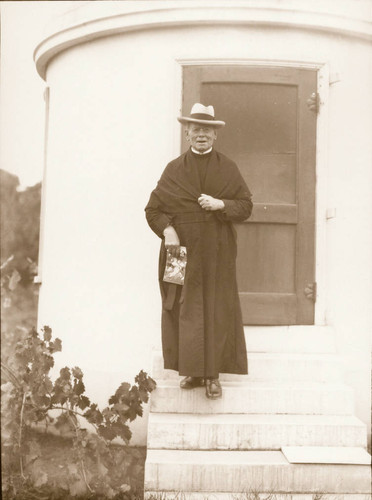 Jerome Ricard, S.J. on steps of Ricard Observatory