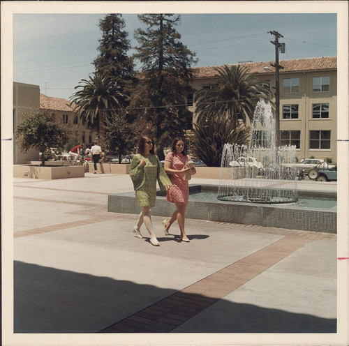 Young Women walking across Benson quad