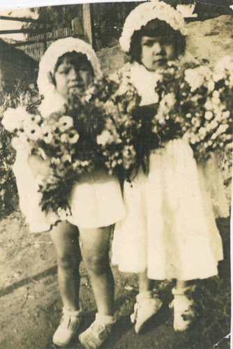 Ofelia Rivera and Evangelina Rivera offering of flowers, East Los Angeles, California