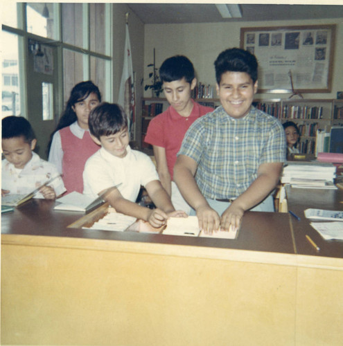Martinez siblings at the City Terrace Library circulation desk, East Los Angeles, California