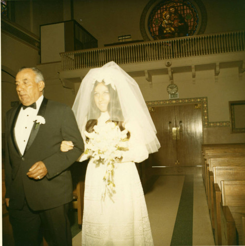 Wedding bride Diana Guerro and father Henry walk the aisle towards the altar