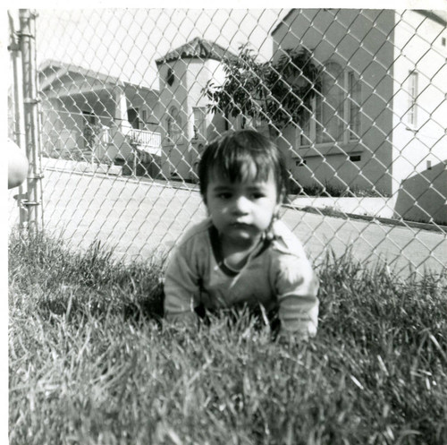 Susan Martinez crawling on the grass, East Los Angeles, California