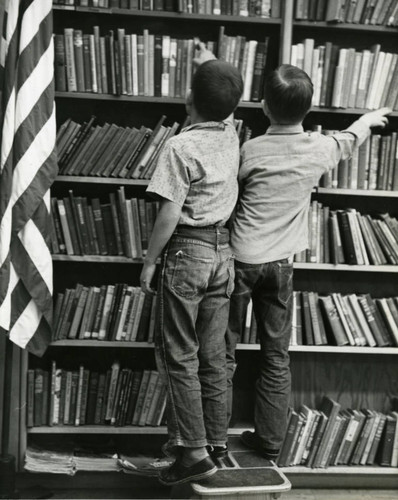 Two boys look for books at the Lancaster Library, Lancaster, California