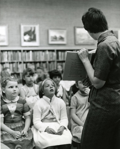 Children observe Barry Shemaria present storytime at the Lancaster Library